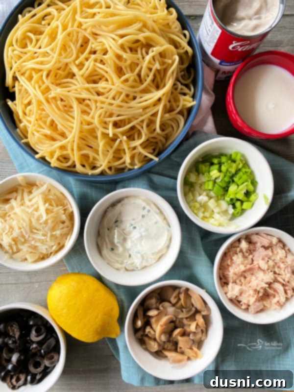 Top view of all the fresh and canned ingredients laid out for making tuna spaghetti
