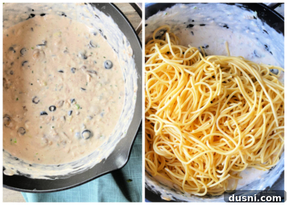 Top view of the creamy sauce with pasta noodles being added and mixed
