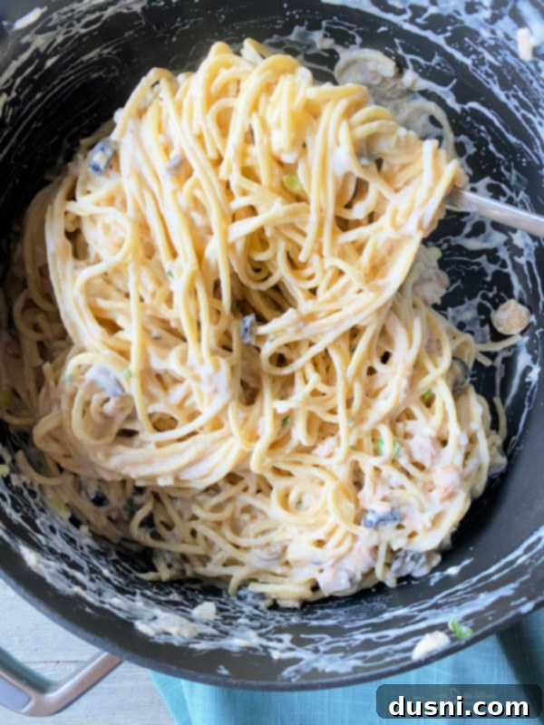 Top view of spaghetti noodles coated in the creamy tuna sauce