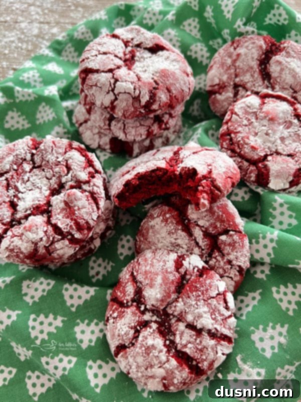 Red Velvet Crinkles Red Velvet Crinkle Cookies resting on a green kitchen towel, ready to be enjoyed.