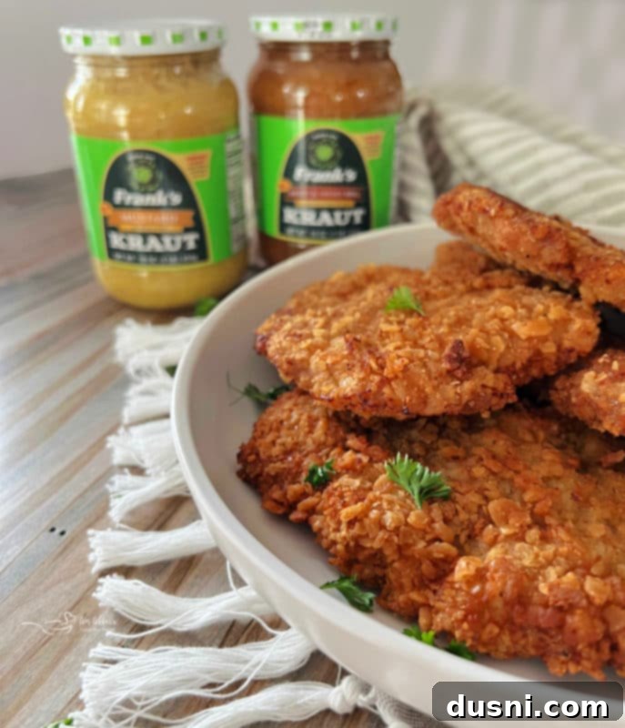 Breaded pork cutlets served with Frank's Kraut and a lemon wedge.