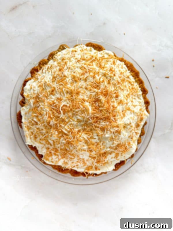Step-by-step image: heavy cream being whipped to stiff peaks in a stand mixer