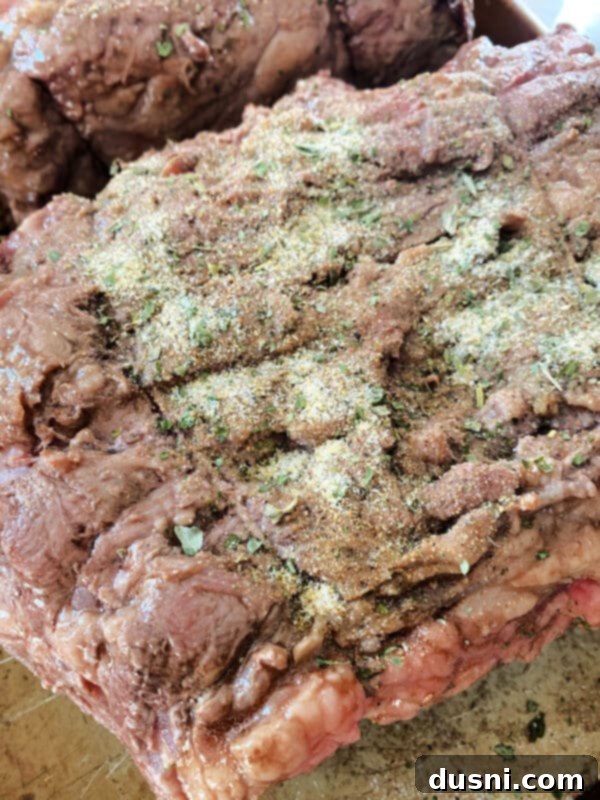 Prime rib roast with herb rub returning to the oven for slow roasting
