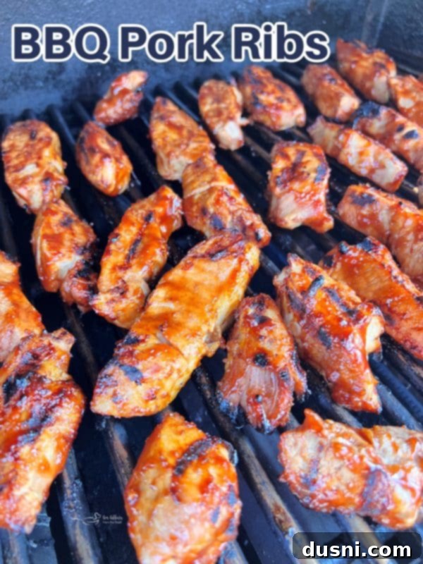 Close-up of succulent grilled BBQ Pork Ribs on a plate with fresh parsley
