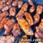 Close up of BBQ Pork ribs on the grill, glistening with sauce.