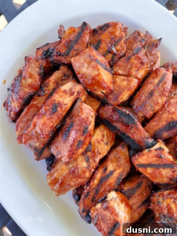 Close-up of succulent BBQ pork ribs on the grill, showing a perfect char