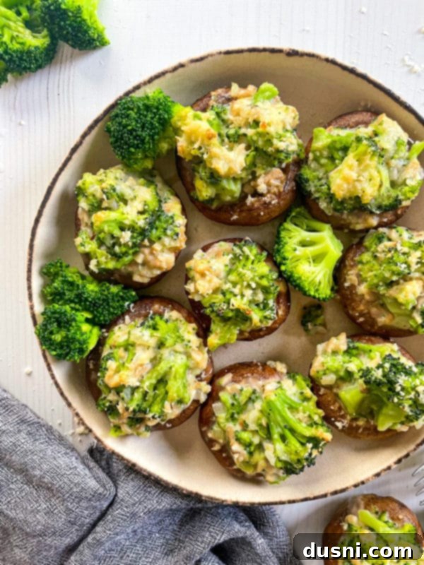 Broccoli Stuffed Mushrooms A plate of perfectly baked broccoli stuffed mushrooms, ready to be served as an appetizer.
