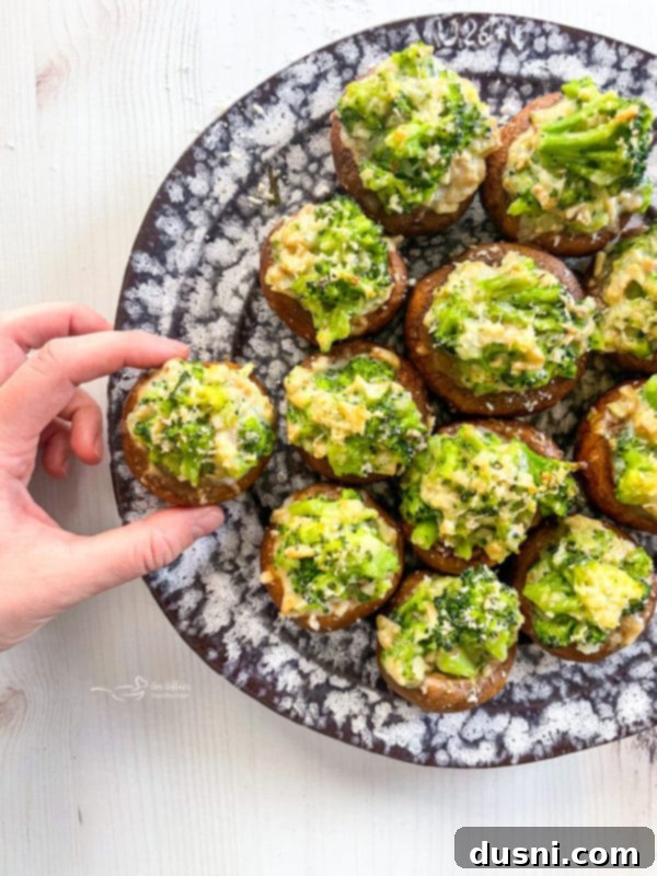 Stuffed Mushrooms Recipe A plate of expertly prepared stuffed mushrooms featuring broccoli and cheese, presented for serving.
