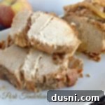 sliced apple pork tenderloin on a white platter, garnished with fresh herbs and text "Apple Pork Tenderloin"