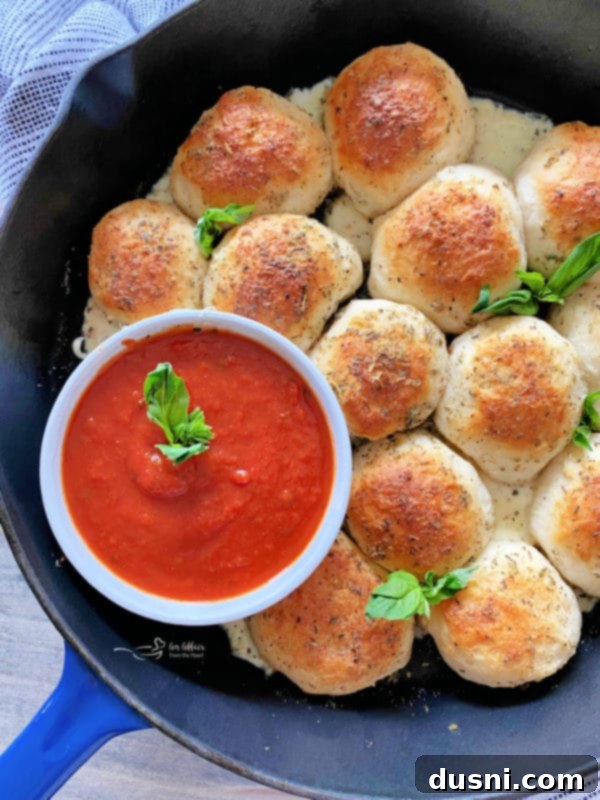 Italian Cheese Bombs in a cast iron skillet with marinara sauce