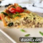 Green Chile Quiche with Sausage side view of sliced quiche