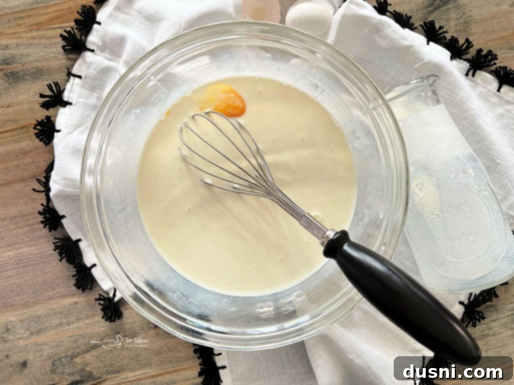 Whisking eggs and half & half in a bowl