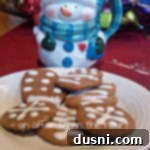 close up of Karen’s Ginger Bread Cookies on a white plate and a snowman mug on a red surface