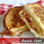 Close up of a delicious sandwich with text "apple bbq pork & smoked gouda grilled cheese"