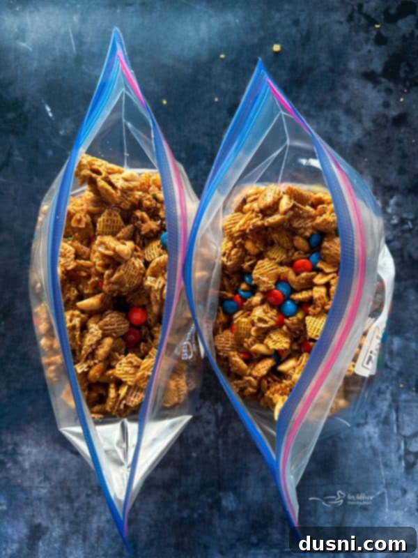 Finished Candy Coated Crispix Mix with M&Ms, cooling on a baking sheet.