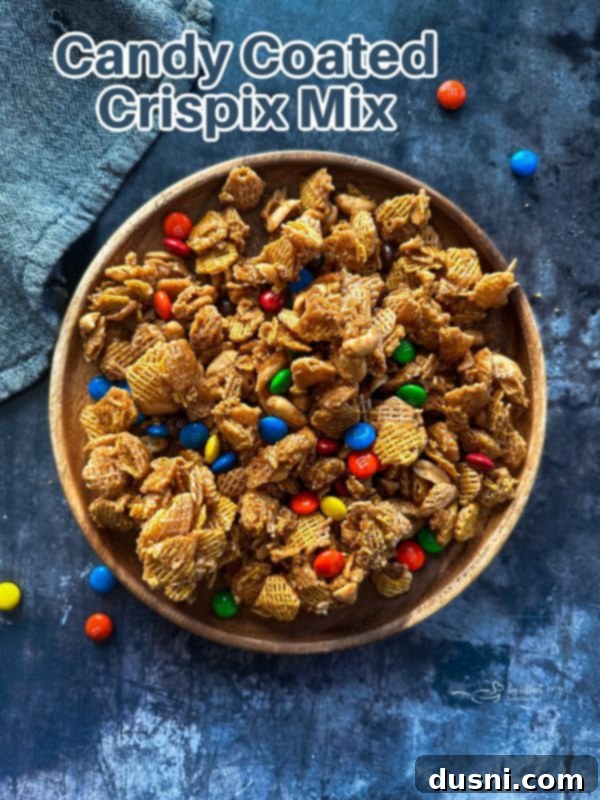 A large batch of Candy Coated Crispix Mix in a wooden bowl, ready to be enjoyed.