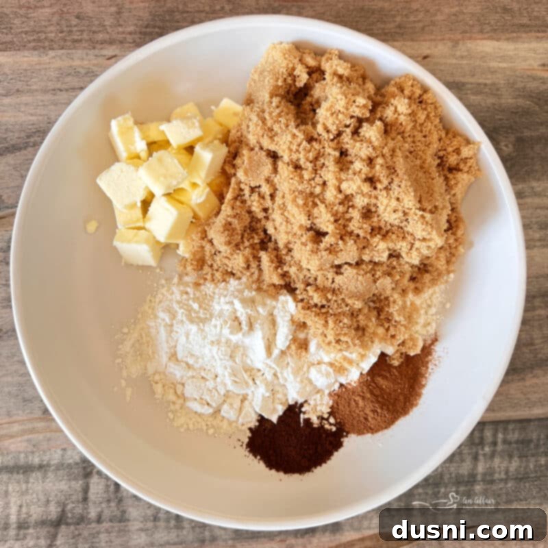 Autumn Spiced Banana Pumpkin Muffins 5 Ingredients for Pumpkin Spice Banana Muffins laid out on a wooden surface, including bananas, pumpkin puree, and spices.