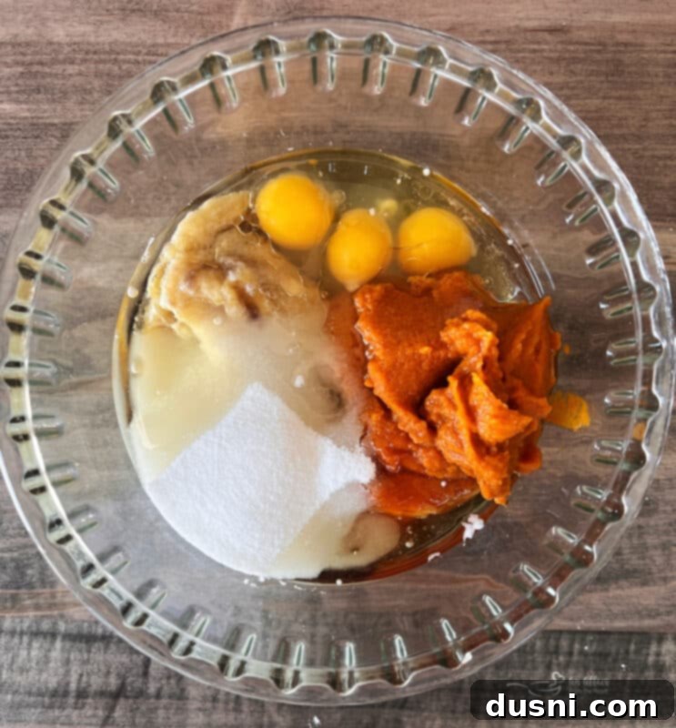Autumn Spiced Banana Pumpkin Muffins 8 Hands mixing streusel topping ingredients in a bowl, showing the crumbly texture