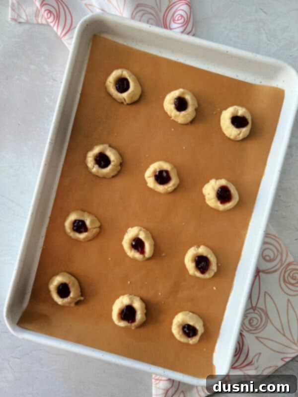 Raspberry Almond Shortbread Jewels 11 Process photo: Making indentations in cookie dough balls with a finger or spoon