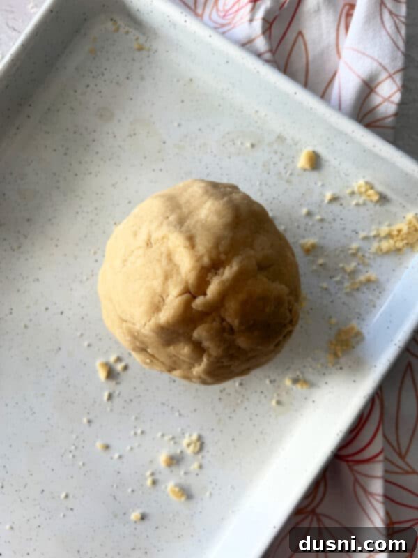Raspberry Almond Shortbread Jewels 8 Process photo: Adding all-purpose flour to the creamed butter and sugar mixture