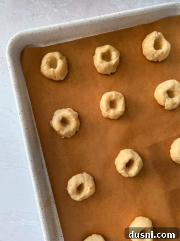 Raspberry Almond Shortbread Jewels 10 Process photo: Rolling cookie dough into balls and placing them on a baking sheet