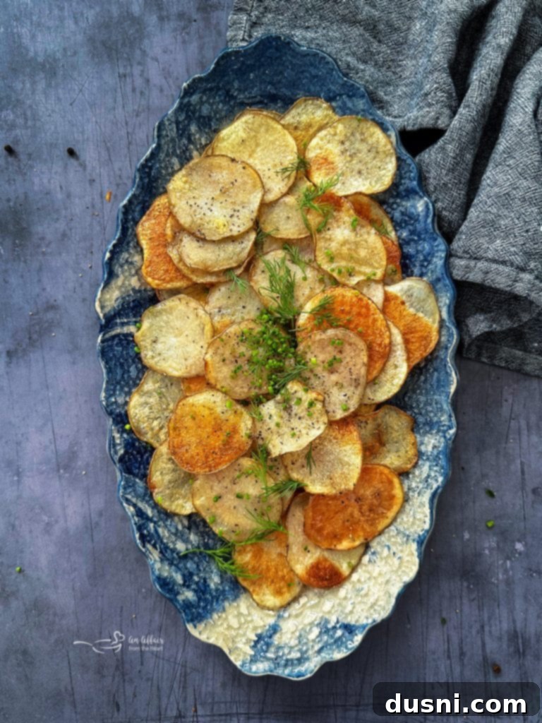 Oven-Fresh Potato Crisps 11 Homemade baked potato chips in a bowl with herbs
