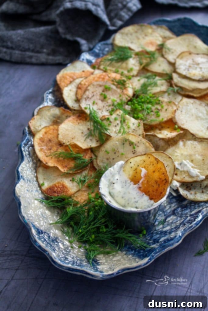 Oven-Fresh Potato Crisps 4 Crispy homemade potato chips arranged in a bowl
