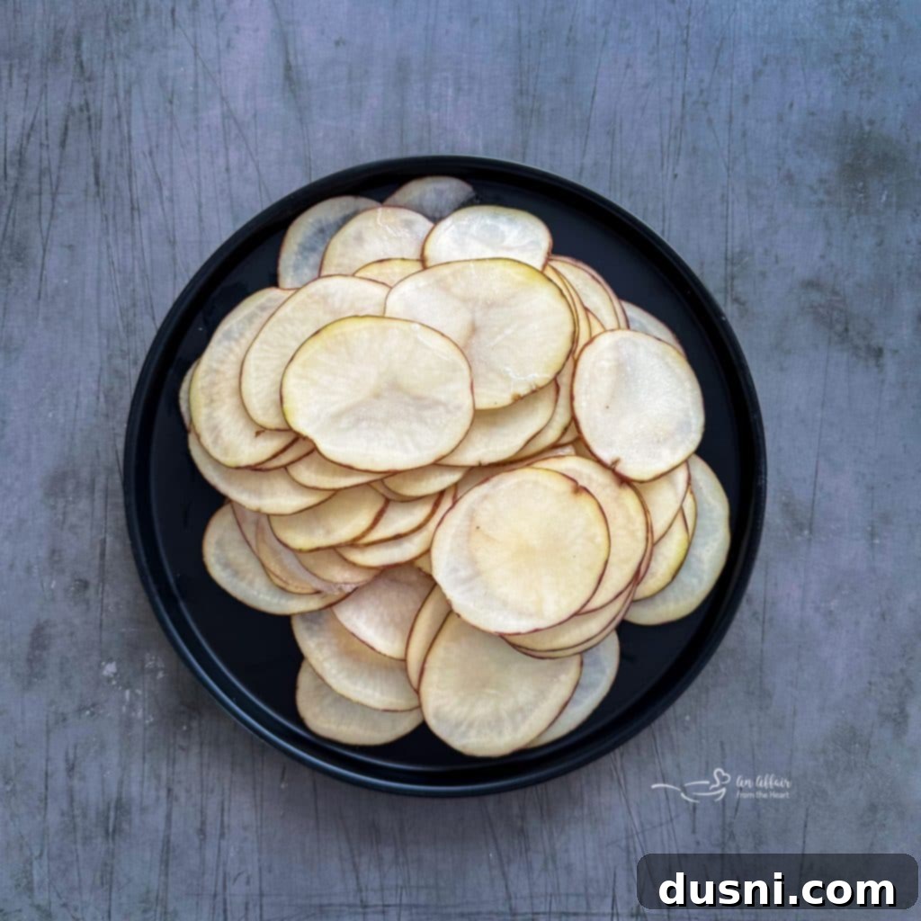 Oven-Fresh Potato Crisps 7 Sliced russet potatoes ready for baking