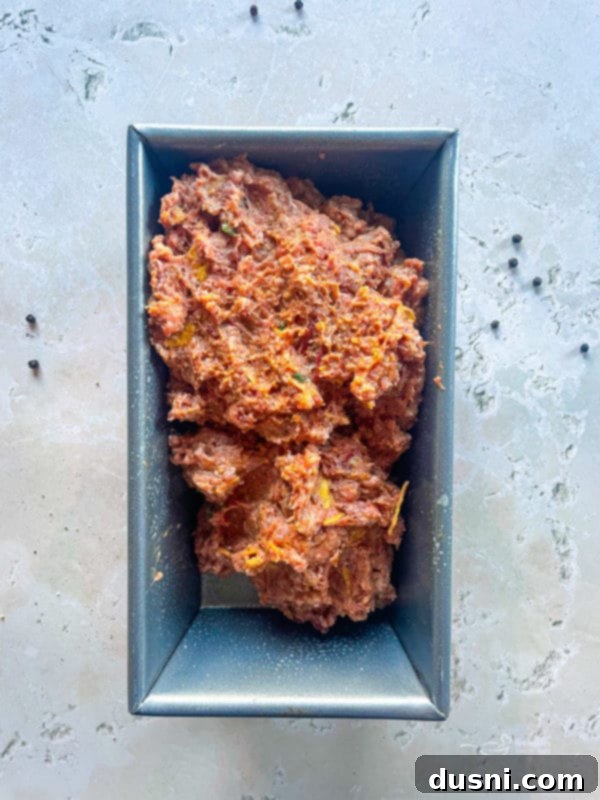 Taco Meatloaf mixture pressed into a loaf pan