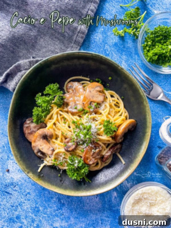 A generous bowl of creamy Cacio e Pepe with mushrooms and a sprinkle of fresh parsley, showcasing its rich texture.