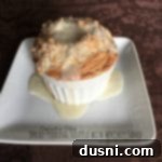 Bread Pudding Soufflé with Whiskey Sauce on a white plate