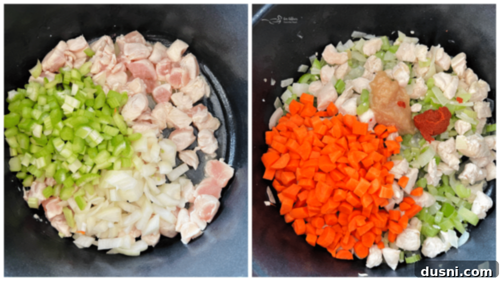 Chicken cooking in a pan with diced carrots, onions, and celery, with a dollop of red curry paste, ready for broth.