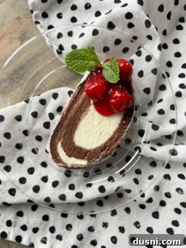 Indulgent Ice Cream Swirl 4 sweet piece of ice cream roll cake with cherry pie filling on top