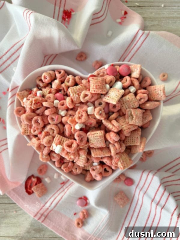 Top view of strawberry Chex Mix in a heart-shaped dish, perfect for Valentine's Day.