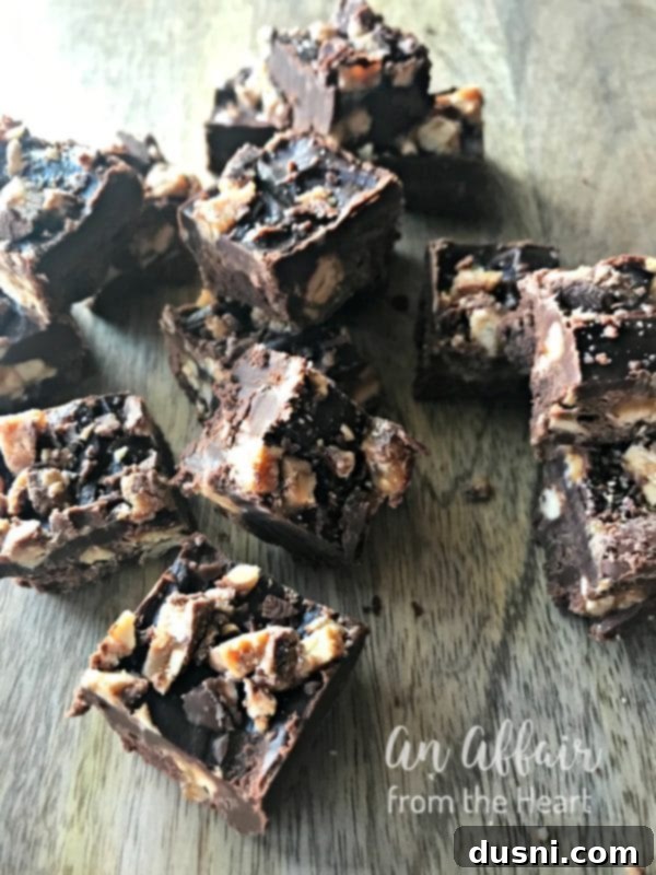 Decadent Candy Bar Fudge 13 Candy Bar Fudge {Snickers Fudge} on a wood table