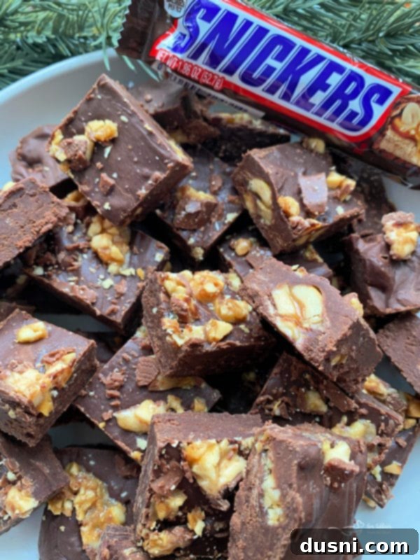 Decadent Candy Bar Fudge 3 Candy bar fudge in a bowl with snickers