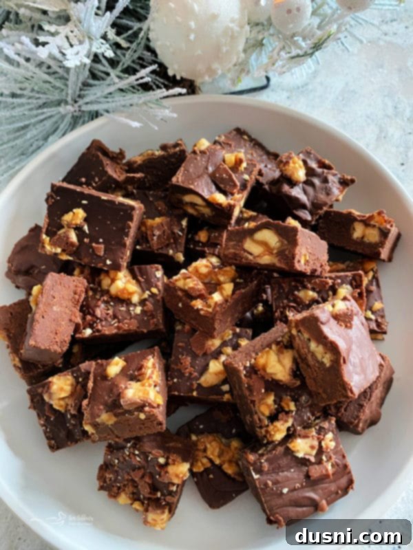 Decadent Candy Bar Fudge 4 Candy Bar Fudge cut into squares, with Snickers pieces