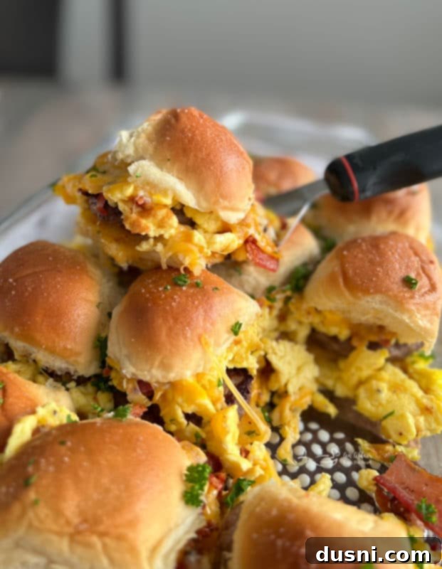 Sausage Egg Sliders Front view of a stack of fresh, warm breakfast sliders, showing off their rich layers of ingredients.