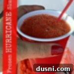 Arctic Hurricane Slush 2 hand holding a frozen hurricane slush with text of the same