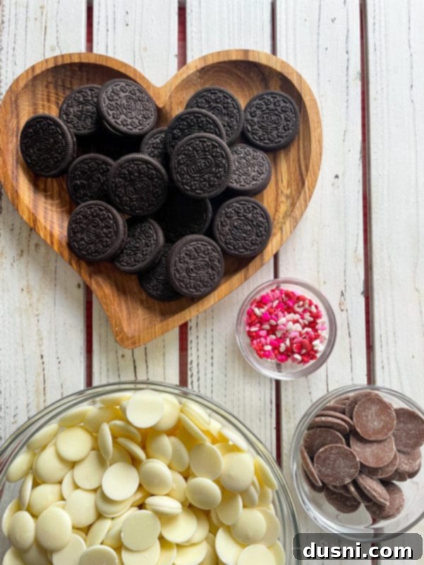 Valentine's Day Bark Oreos in heart dish with white candy melts and milk chocolate with sprinkles