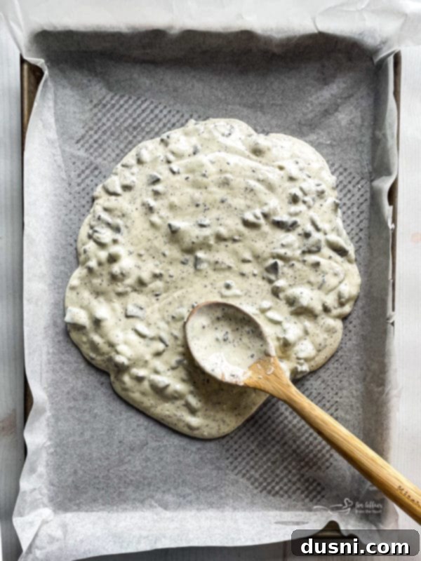 Midnight Oreo Crunch 3 spreading melted white chocolate with chopped Oreos