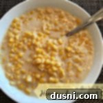 Creamed corn in a serving bowl with text "homemade creamed corn"