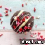 white chocolate drizzled and candy sprinkled hot chocolate bomb