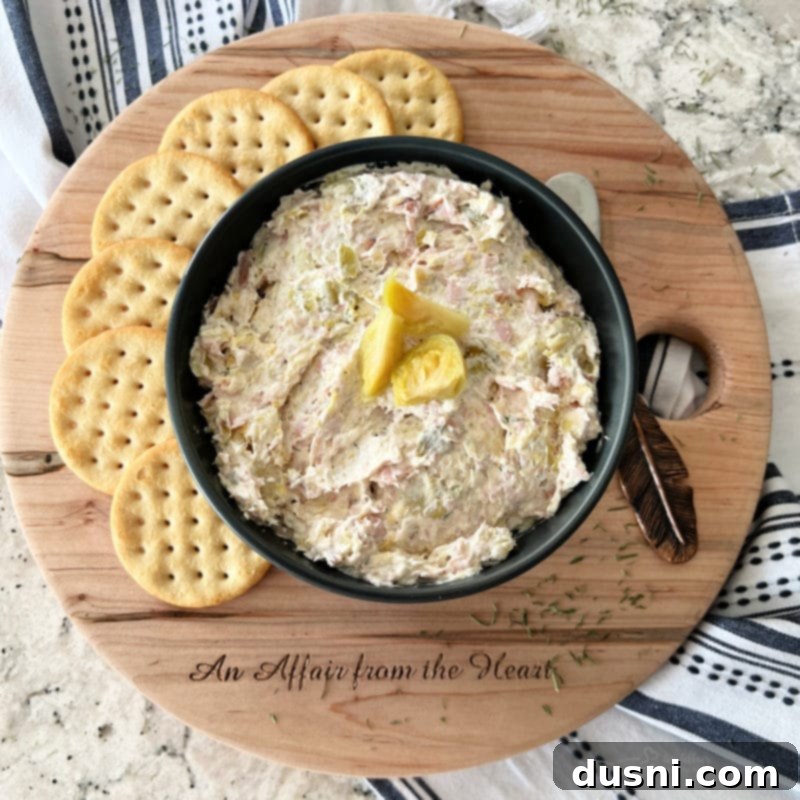 Creamy Dill & Brussels Sprout Dip 11 Dilled Brussels Sprouts Dip in a serving bowl with a small bowl of fresh dill