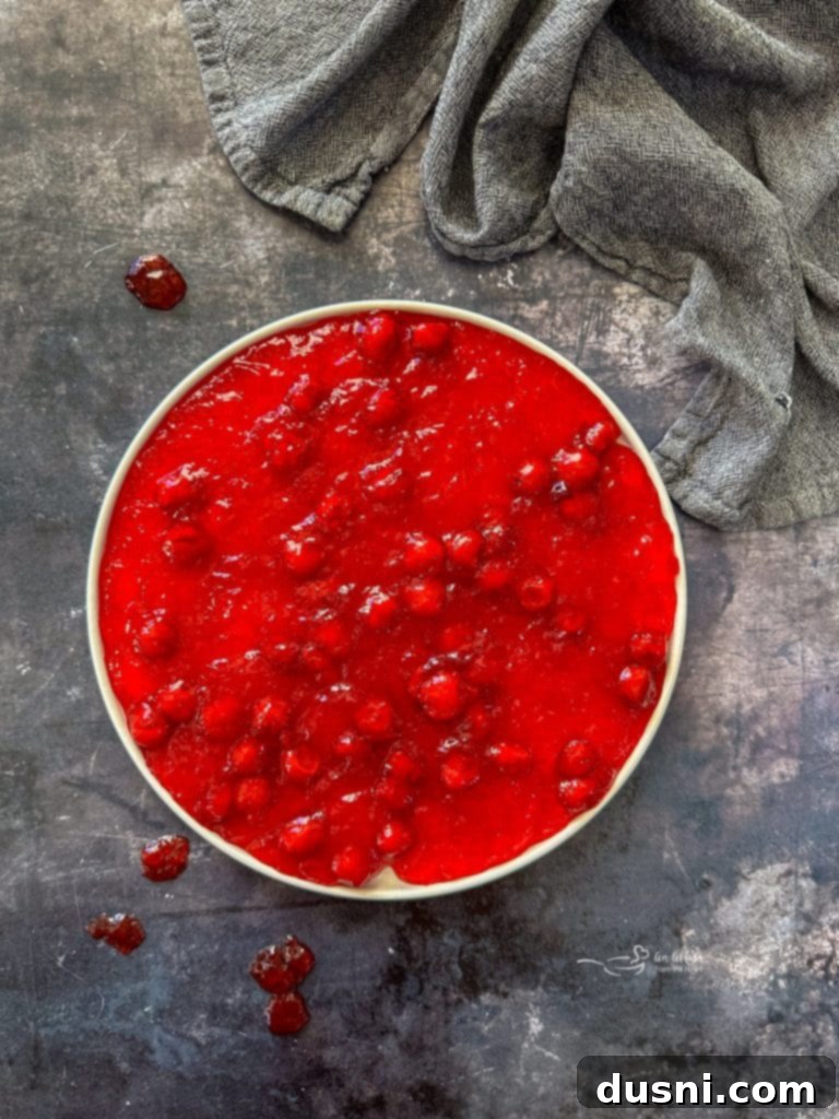 Holiday Cherry Pie Bliss 2 A beautifully presented Festive Cherry Pie Jell-O Salad in a serving bowl, ready for enjoyment.