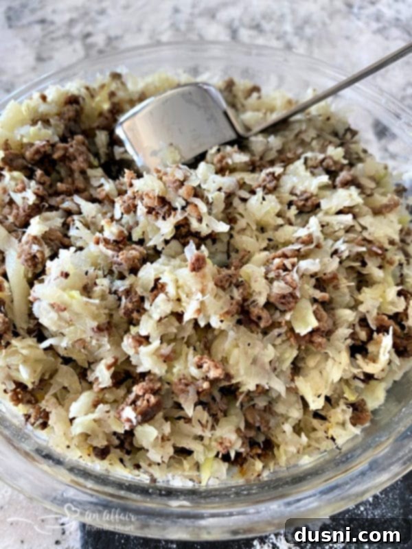 Runza filling in a bowl, showcasing cooked beef, cabbage, and onions
