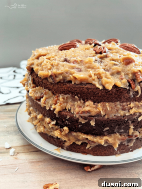 German chocolate cake on white plate with coconut pecan frosting 