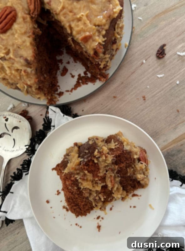 one slice of German chocolate cake on white plate with coconut pecan frosting 