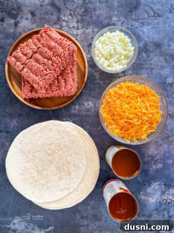 Quick & Easy Ground Beef Enchiladas 4 A dish of easy ground beef enchiladas with a spoon serving a portion, showing the delicious filling.