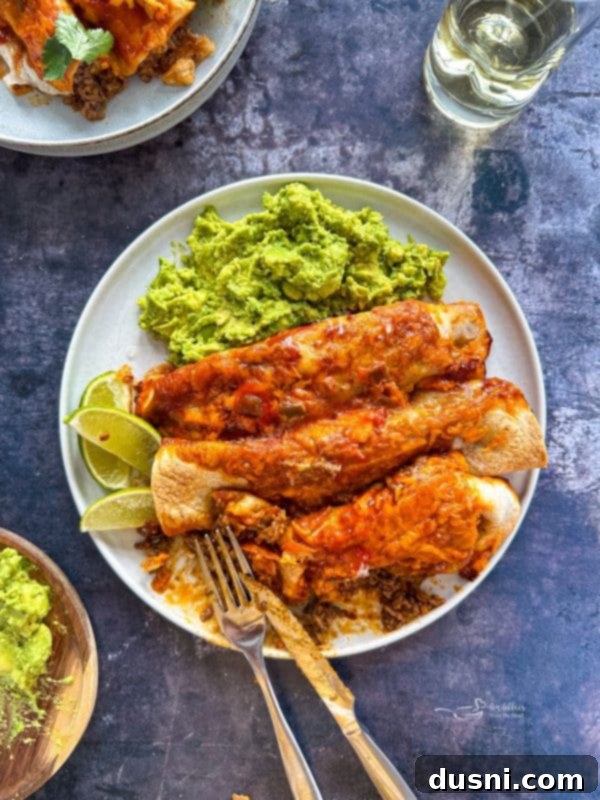 Quick & Easy Ground Beef Enchiladas 5 A close-up shot of a single perfectly rolled ground beef enchilada, ready for baking.